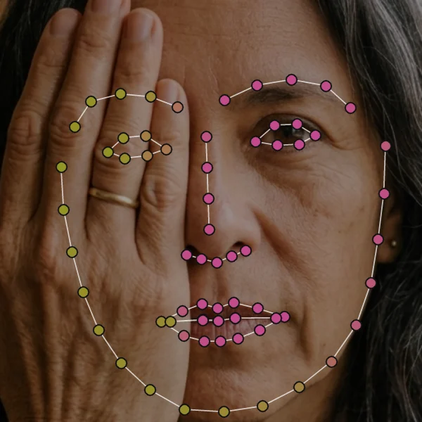 Hand over right eye: the hidden eye, brow and jaw side coloured olive, visible landmarks pink.
